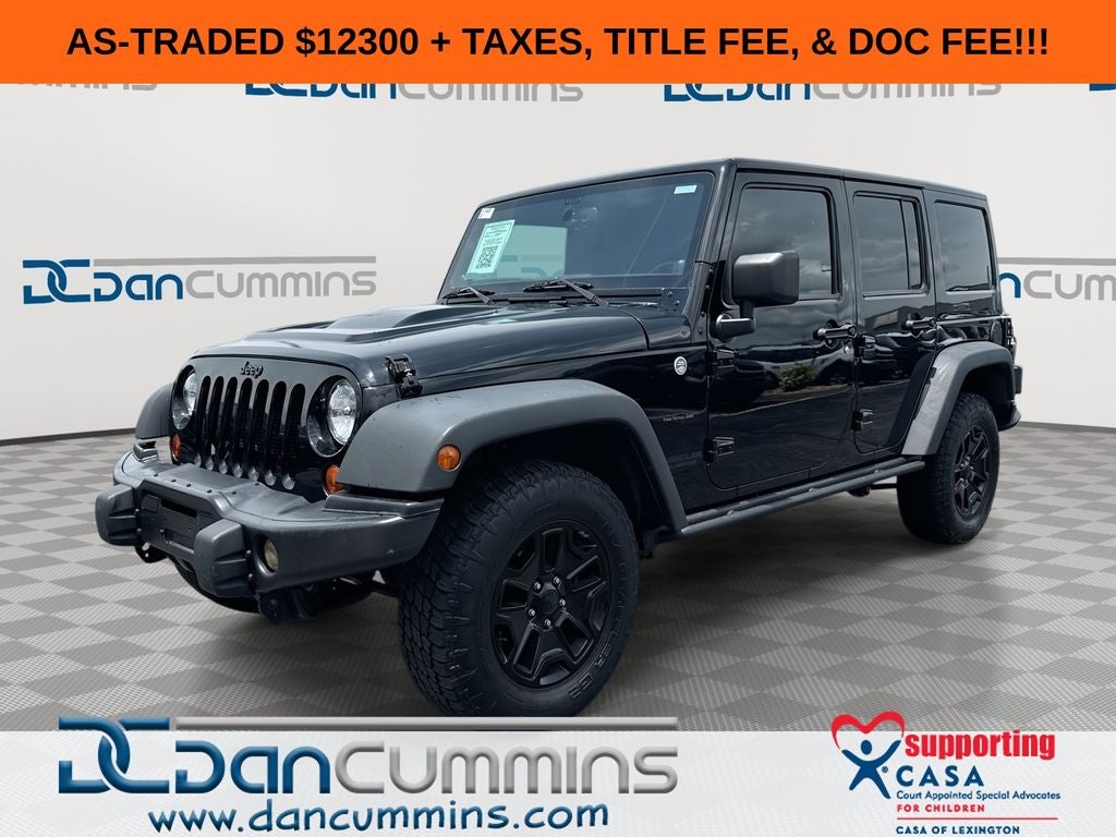 2013 Jeep Wrangler Unlimited Sahara in Black Clearcoat — front three-quarter view