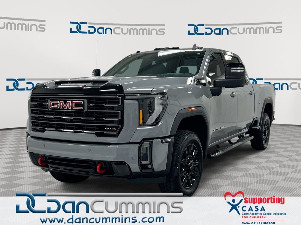2024 GMC Sierra 2500HD AT4 in Thunderstorm Gray — front three-quarter view