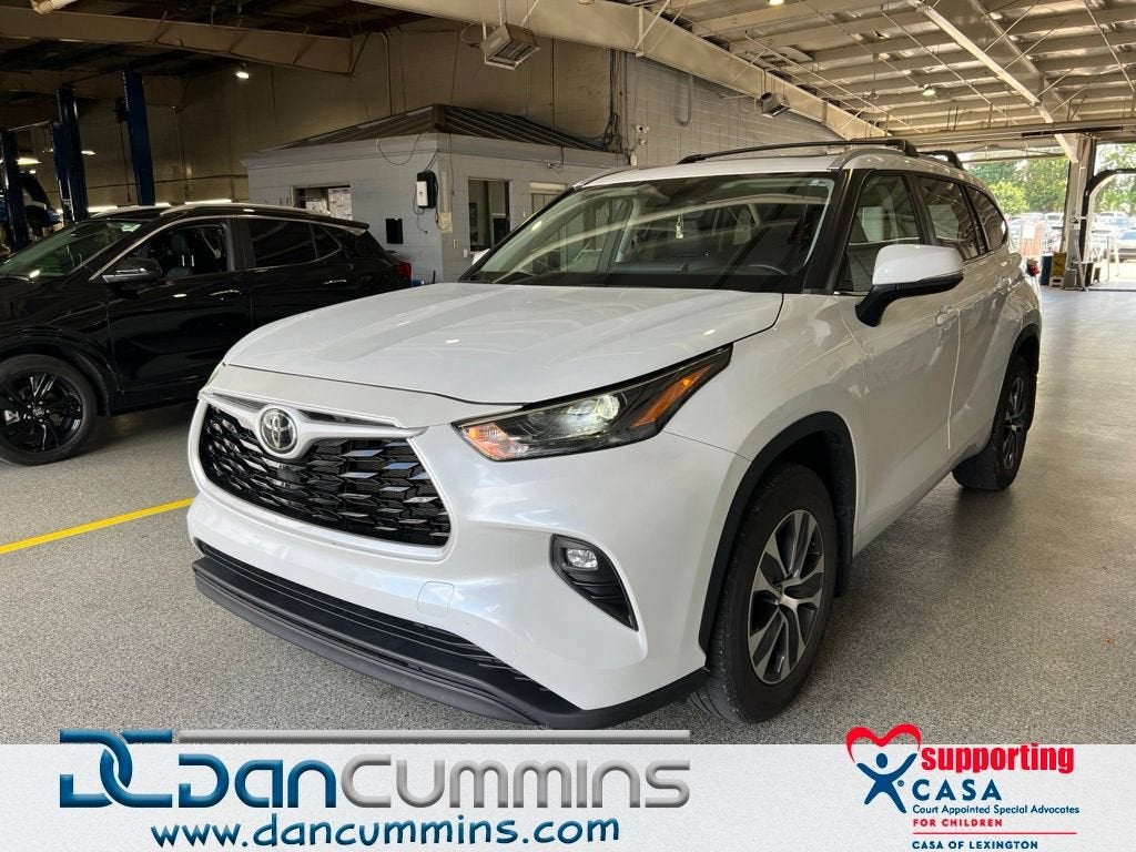 2023 Toyota Highlander L in White — front three-quarter view